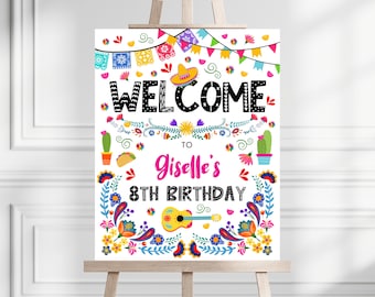 May include: A colorful welcome sign with a fiesta theme. The sign says "Welcome to Giselle's 8th Birthday" with a sombrero, flowers, and a guitar.