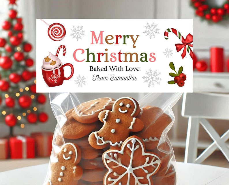 May include: A clear cellophane bag filled with gingerbread cookies, including gingerbread men and snowflake shapes. A banner above reads "Merry Christmas Baked With Love From Samantha" with festive illustrations of candy canes, snowflakes, and a mug of hot cocoa.