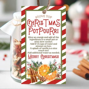 May include: A red and green striped gift tag with the text "Stove Top Christmas Potpourri" and instructions for making a stovetop potpourri. The tag features a festive illustration of oranges, cinnamon sticks, and star anise.
