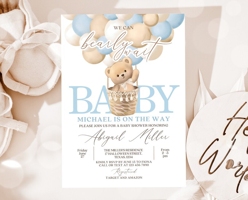 May include: A baby shower invitation with a blue and beige color scheme. The invitation features a teddy bear in a hot air balloon made of balloons. The text on the invitation reads "We can barely wait" and "Baby Michael is on the way".