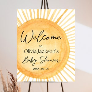 Könnte beinhalten: Willkommen zur Babyparty von Olivia Jackson Schild mit einem Aquarell-Sonnenmotiv in Gelb- und Orangetönen. Das Datum der Veranstaltung ist 20XX.09.06.