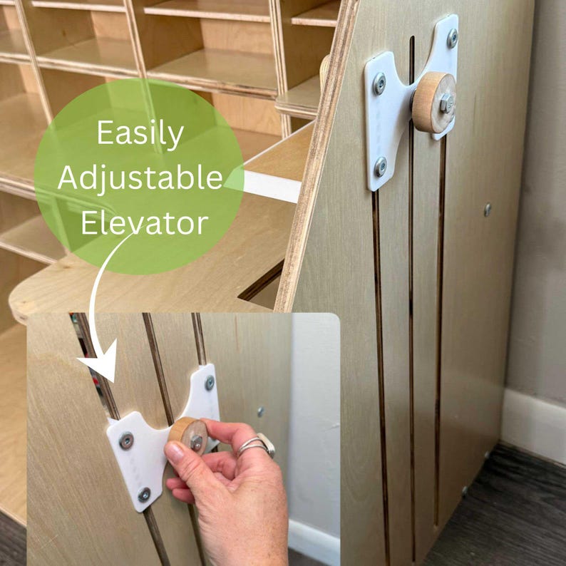 May include: A wooden cabinet with an adjustable elevator mechanism. The cabinet is made of light-colored wood and features a series of shelves. The elevator mechanism is white with a wooden knob. The text "Easily Adjustable Elevator" is in a green circle.