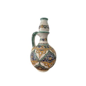 May include: A white ceramic pitcher with a green, blue, and yellow geometric pattern. The pitcher has a round body and a narrow neck with a spout.