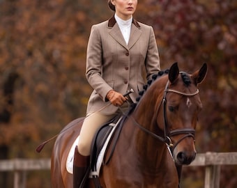 May include: A brown equestrian blazer with a dark brown velvet collar and three buttons, worn with a white collared shirt, tan breeches, and brown leather riding boots, while mounted on a brown horse with a black mane and leather bridle.