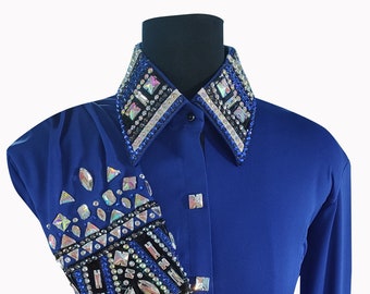 May include: A royal blue long-sleeved shirt with a black and white geometric design on the collar and cuffs. The design is embellished with rhinestones and crystals.
