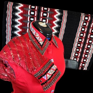 May include: Red sequin and mesh long-sleeve shirt with a black and silver embellished collar and cuffs. The shirt is on a mannequin and has a black background.