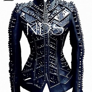 May include: Black leather jacket with a geometric design and studded embellishments. The jacket has a zipper closure and a stand-up collar.