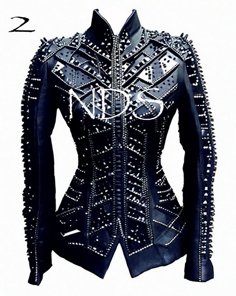 May include: Black leather jacket with a geometric design and studded embellishments. The jacket has a zipper closure and a stand-up collar.