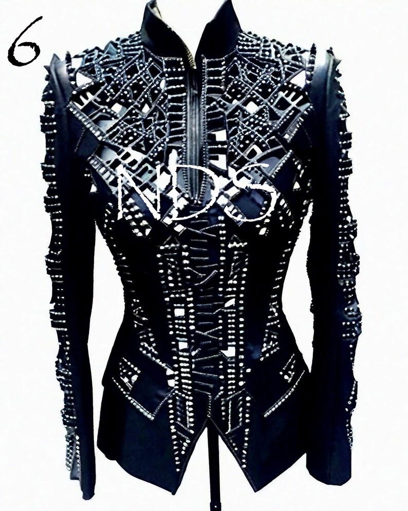 May include: Black leather jacket with a cut-out design and silver studs. The jacket has a zipper closure and long sleeves.