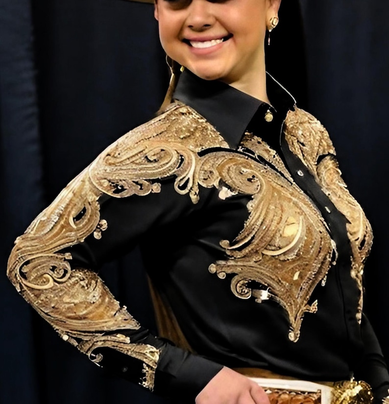 May include: A black long-sleeved shirt with gold embroidery. The embroidery features a paisley design.