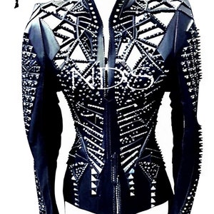 May include: Black leather jacket with a geometric design and silver studs. The jacket has a zipper closure and long sleeves.