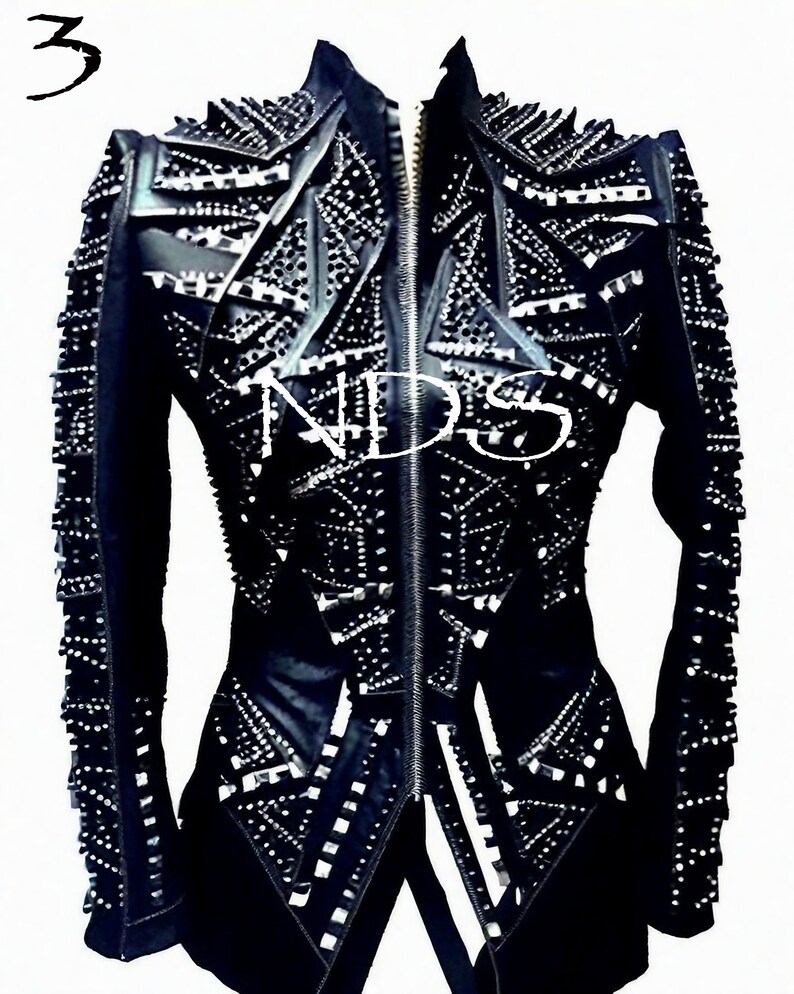 May include: A black leather jacket with a zipper closure and a geometric design. The jacket is covered in silver studs and has a high collar.