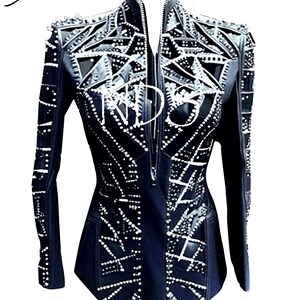 May include: Black leather jacket with a geometric design and silver embellishments. The jacket has a zipper closure and a stand-up collar.