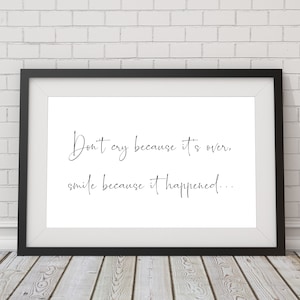 May include: Black and white framed print with the quote "Don't cry because it's over, smile because it happened..." on a white background.
