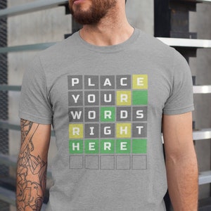 May include: A gray t-shirt with a crossword puzzle design. The puzzle says "PLACE YOUR WORDS RIGHT HERE".