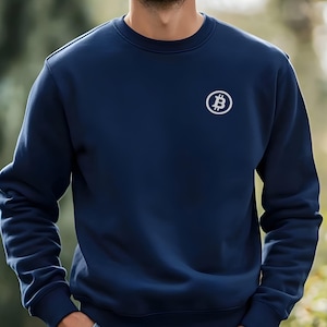 May include: A navy blue sweatshirt with a white Bitcoin logo embroidered on the chest.