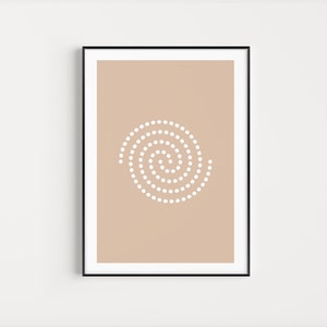 May include: A beige framed print with a white spiral design made of dots.