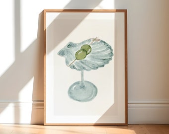 May include: A watercolor painting of a martini glass with two green olives on a skewer. The glass is shaped like a seashell and is painted in shades of blue and green.