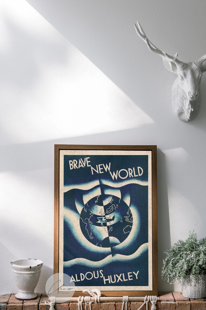 May include: A framed print of "Brave New World" by Aldous Huxley. The artwork features a blue and white design with a world map at the centre. The print is in a brown wooden frame and is displayed on a white wall.