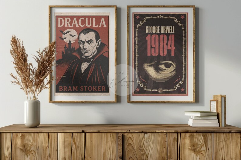 May include: Two framed vintage posters. The left one features Dracula with the text "Dracula" and "Bram Stoker." The right poster displays "George Orwell 1984" with an eye graphic. Both are in gold frames, displayed on a wooden cabinet.