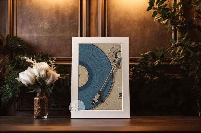 May include: A framed print featuring a vintage turntable with a blue vinyl record. The artwork is set against a warm, dark background with a vase of white roses and greenery. The print is in a white frame.