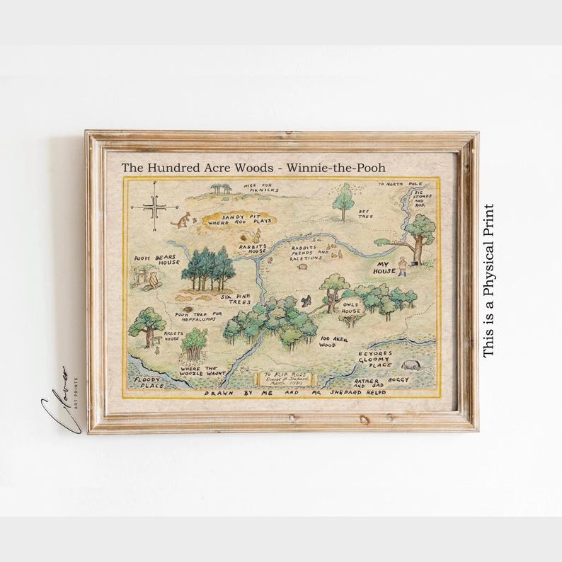 May include: A framed print of a map of the Hundred Acre Woods from Winnie-the-Pooh. The map is hand-drawn with various locations labeled, including Pooh's house, Rabbit's house, and the Floody Place. The print is in a wooden frame.