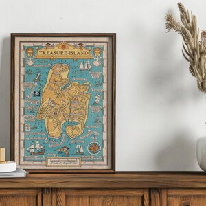 May include: A vintage-style framed map of Treasure Island, featuring a detailed illustration of the island with various landmarks and locations. The map is printed on a blue background with yellow and brown accents.