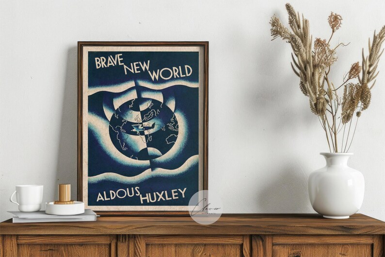 May include: A framed print of Aldous Huxley's "Brave New World" with a blue and white globe design. The print is displayed on a wooden cabinet. A white vase with dried plants and a small white mug are also visible.