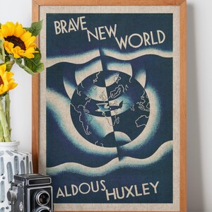 May include: Framed vintage poster with the text "BRAVE NEW WORLD" and "ALDOUS HUXLEY". The artwork features a stylized globe in shades of blue and white. A vintage camera and sunflowers in a vase are in the foreground.