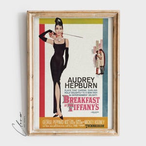 May include: A vintage movie poster for the film "Breakfast at Tiffany's" featuring Audrey Hepburn in a black dress and a long pearl necklace. The poster has a red, yellow, and white color scheme and includes the text "Audrey Hepburn plays that daring, darling Holly Golightly to a new high in entertainment delight!" and "Breakfast at Tiffany's".
