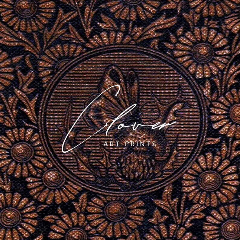 May include: A close-up of a brown and black floral pattern with a circular design in the center. The center design features a stylized flower with the text "Clover Art Prints".