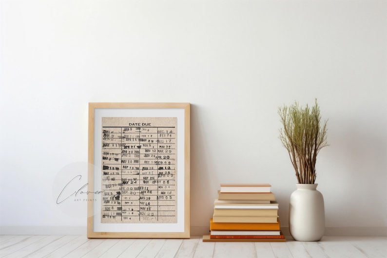 May include: A framed print of a vintage date due list with handwritten dates in black ink. The print is in a light wood frame and is hanging on a white wall.