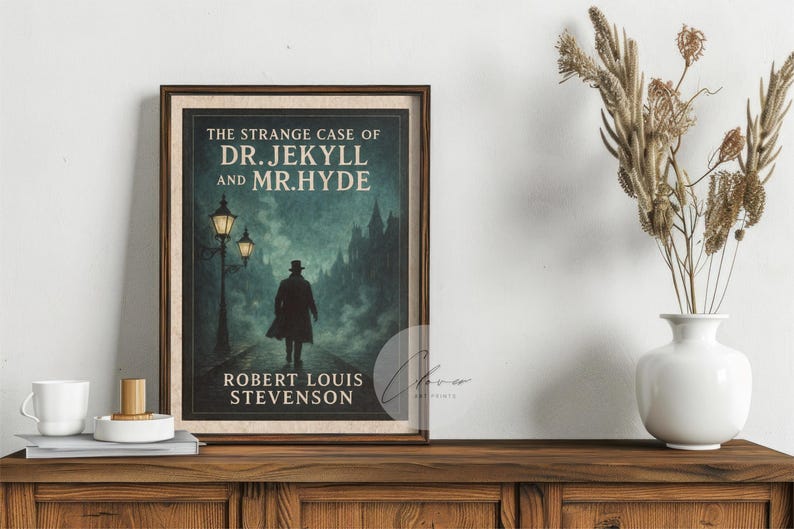 May include: A framed print of "The Strange Case of Dr. Jekyll and Mr. Hyde" by Robert Louis Stevenson. The artwork depicts a silhouetted figure walking on a cobbled path, with street lamps and a dark cityscape in the background. The print is displayed on a wooden cabinet.