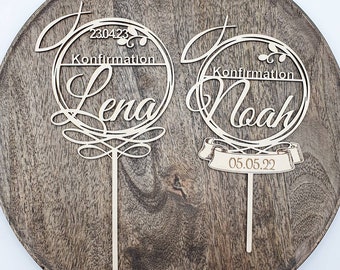 May include: Two wooden cake toppers with a circle design and the names Lena and Noah. The toppers also include the text "Confirmation" and the dates "23.04.23" and "05.05.22".