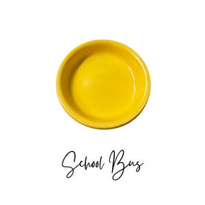 May include: A bright yellow ceramic dish with a smooth, rounded rim. The dish is empty and ready to be filled.