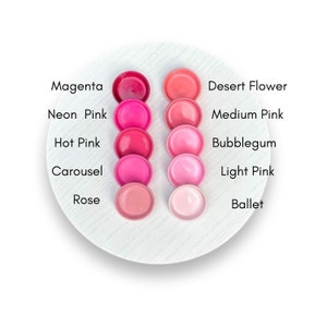 May include: A color chart of ten different shades of pink lipstick, from magenta to ballet. The shades are labeled with their names.