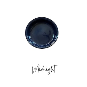 May include: A deep blue ceramic pie plate, with the word "Midnight" written in cursive below it.