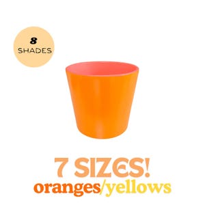 May include: A bright orange planter with a pink rim. The planter is available in 7 sizes and 8 shades of orange and yellow. The text "7 SIZES! oranges/yellows" is printed below the planter.