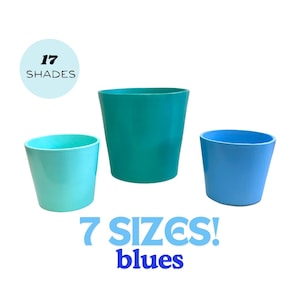 May include: Three different sized ceramic planters in shades of blue. The largest planter is teal, the medium planter is light blue, and the smallest planter is a lighter shade of blue. The text "17 SHADES" and "7 SIZES! blues" is printed below the planters.