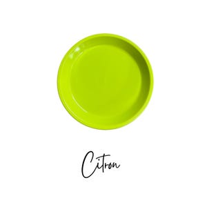 May include: A bright yellow round ceramic dish with the word "Citron" written in black below it.