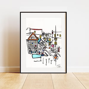 Puede incluir: Dibujo en blanco y negro de una escena de calle con edificios coloridos. Los edificios tienen ventanas y puertas. La calle está vacía excepto por unos pocos coches. El dibujo está firmado "Steve Brown 2022".