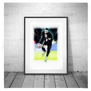 May include: A black and white illustration of a football player in a black kit catching a football. The player is in mid-air and the background is blurred.
