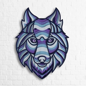 May include: A blue and purple layered paper cut-out of a wolf's face. The wolf's face is detailed with a layered design of blue and purple stripes.