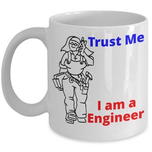May include: White ceramic mug with a black and white cartoon illustration of a person wearing a tool belt and holding a hammer. The text "Trust Me I am a Engineer" is printed in blue and red on the mug.