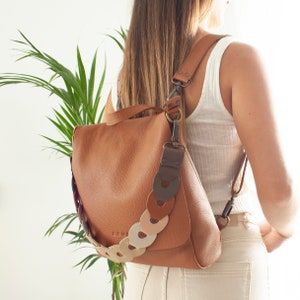 Leather sling backpack for versatile use. Compact small backpack for daily essentials. Laptop bag with secure compartments. 7 colors. LEA
