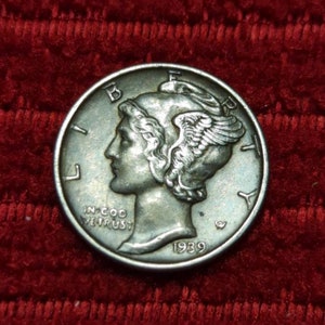 May include: A silver 1939 Walking Liberty Half Dollar coin with the words "Liberty" and "In God We Trust" on the obverse side.