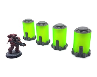 May include: Four green and gray plastic containers with a textured surface. The containers are cylindrical and have a rounded top. The containers are arranged in a row on a white surface.