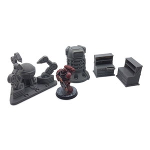 May include: A set of five gray plastic miniature models, including a robot with articulated arms, a tall cylindrical structure with a round top, a space marine figure, and two small cabinets with shelves.