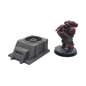 May include: A gray plastic model of a sci-fi building with a circular fan on top. The model is about the size of a miniature action figure.