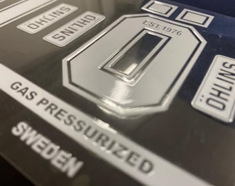 Pair of OHLINS lightly embossed pre-spaced stickers, white colour